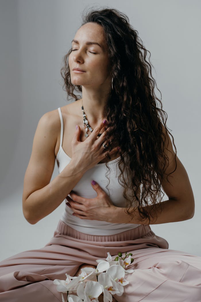 service-04 Portrait of a serene woman meditating with eyes closed, capturing relaxation and mindfulness.